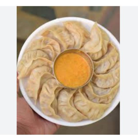 Momos decorated in a plate wIth achar
