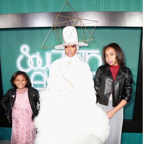 Mars Merkaba Thedford with her mother, Erykah Badu, and elder sister, Puma during an event