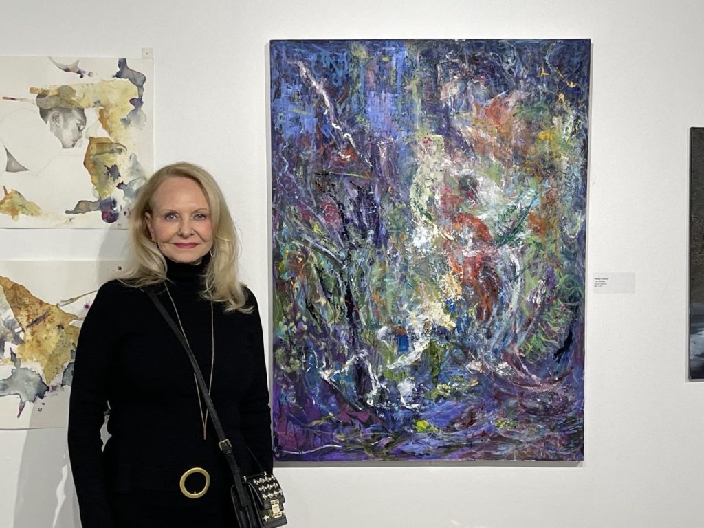 Renee Chahoy standing with her painting